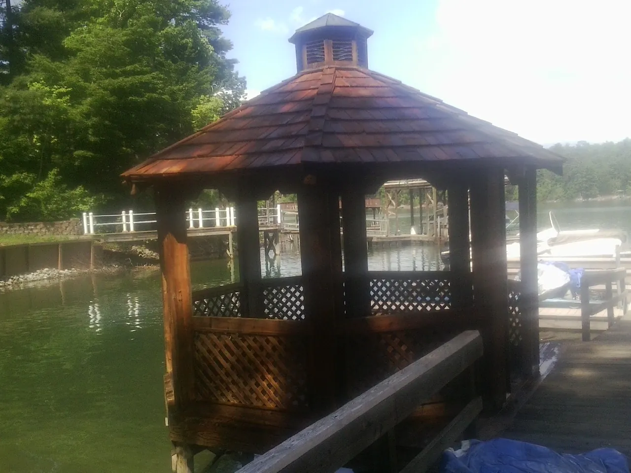 Cedar shake gazebo roof rebuilt on a lake dock in Eunice